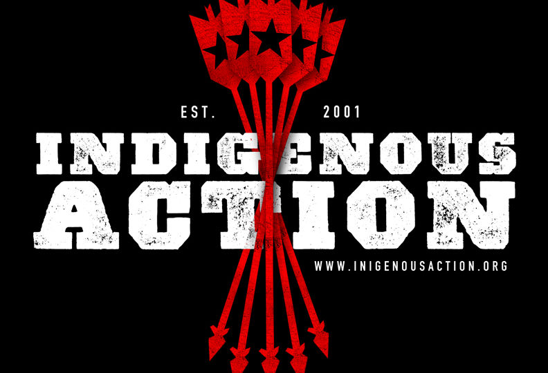 Graphic logo for Indigenous Action -- white words on black background with red arrows through center. Established 2001, www.IndigenousAction.org. 